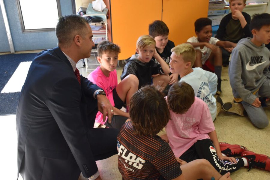 Meeting them at their Level: Dr. Todd Bauer engages with some elementary school students during the 2022-2023 school year. 