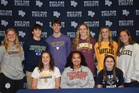 All smiles for signing day: Nine North Penn student-athletes stand celebrating signing day 