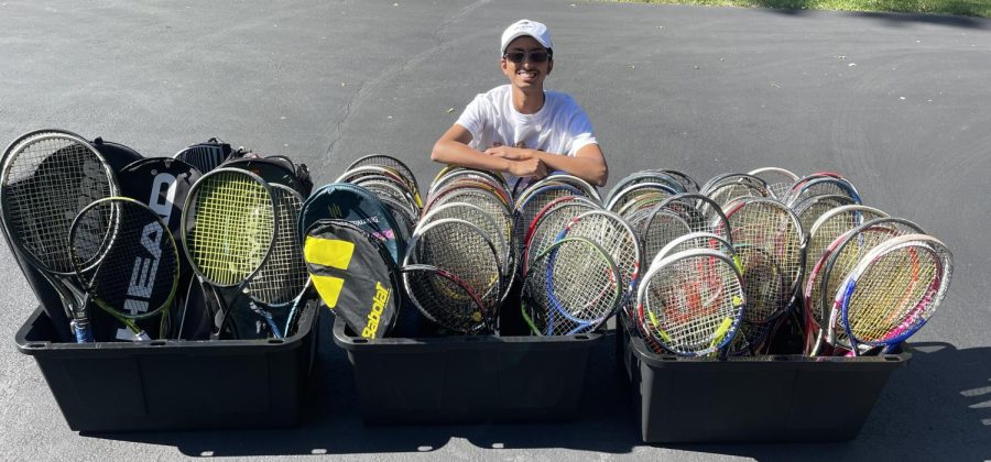 Iyengar poses with all the rackets people donated to Second Serve.