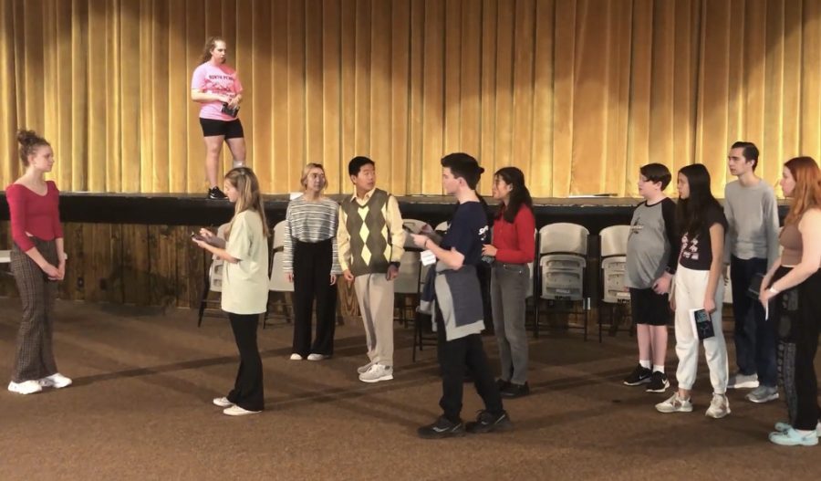 North Penn actors rehearsing a scene of a media event.