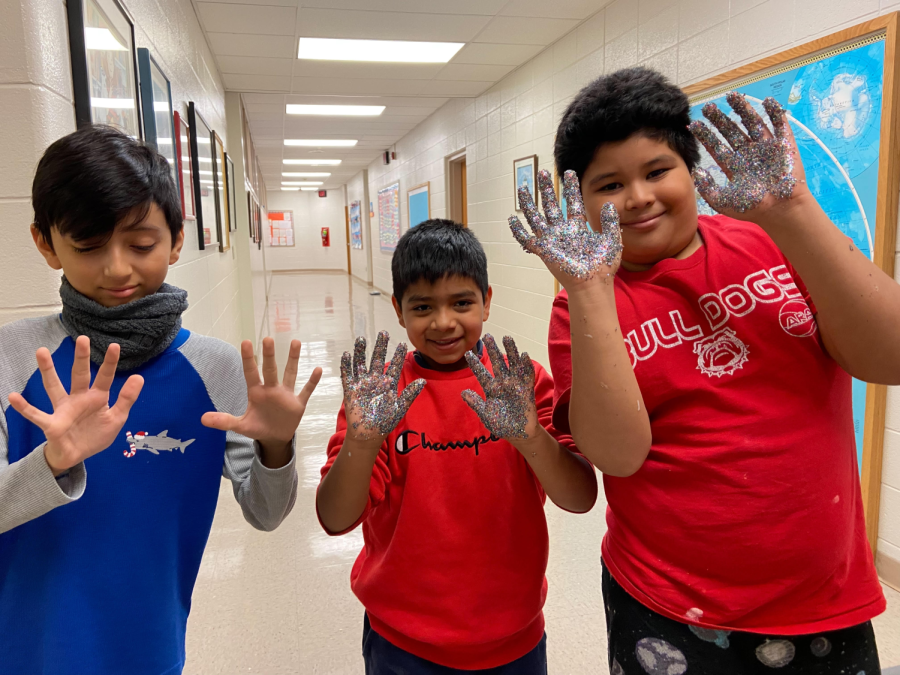 Mynor Nova-Aguirre, Elkin Alverenga, and Juan Araujo Amaya  pose with the aftermath of their glitter hands.