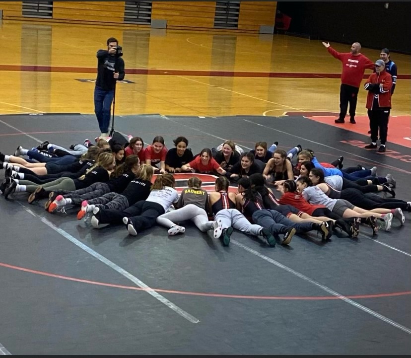 n: Girls from all across the area gather together to share their love for wrestling and encourage one another in the fight to make it a sanctioned sport.