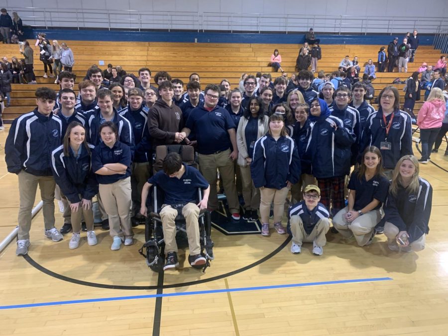 United as one: The Unified Bocce team gathered for a a picture in the center of the Navy gym celebrating their win