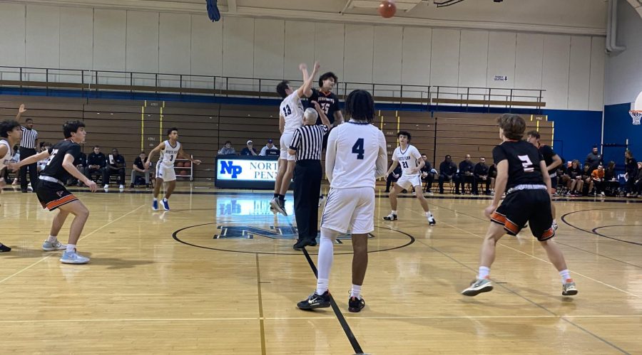 TIP OFF - North Penns Ryan Zeltt wins the tipoff in the Knights game against Pennsbury on Tuesday, January 3rd, 2023. 