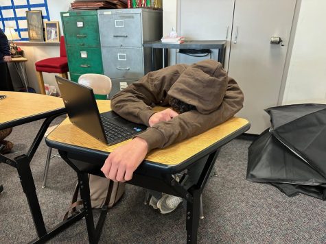 Tired student can’t keep their eyes open in school.