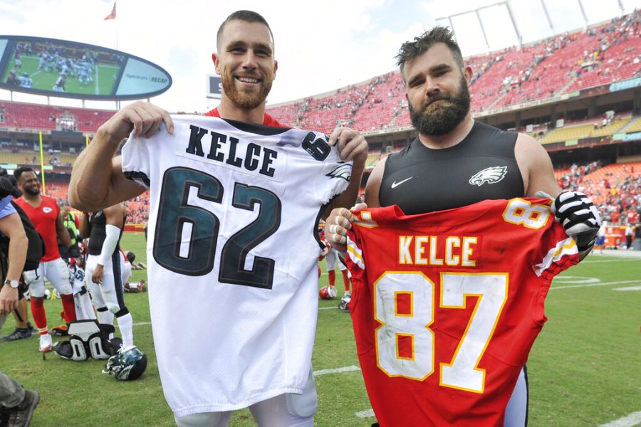 FILE - Kansas City Chiefs tight end Travis Kelce, left, and his brother, Philadelphia Eagles center Jason Kelce (62) exchange jerseys following an NFL football game in Kansas City, Mo., on Sept. 17, 2017.  For the first time in Super Bowl history, a pair of siblings will square off on the NFL’s grandest stage. (AP Photo/Ed Zurga, File)