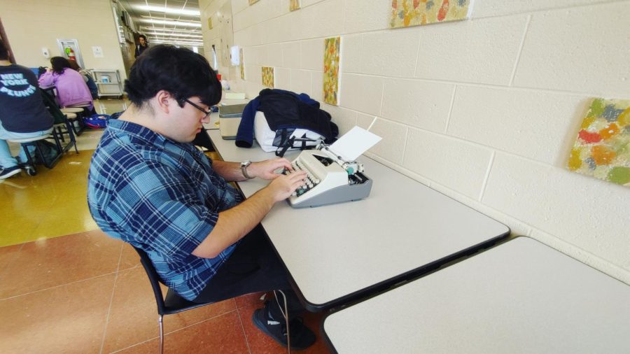 Max Wein in his natural environment, making good use of a rare script typewriter.