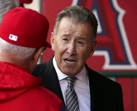 FILE - Los Angeles Angels owner Arte Moreno, right, talks with Angels manager Joe Maddon prior to a baseball game against the Cleveland Guardians, April 26, 2022, in Anaheim, Calif. Moreno has decided not to sell his team. He took his franchise off the market Monday, Jan. 23, 2023, after announcing his plan to explore a sale of the team last August. The 76-year-old owner met with prospective buyers during the winter. (AP Photo/Mark J. Terrill, File)