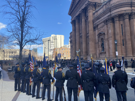 Officers from around the nation outside the Cathedral Basilica of Saints Peter and Paul waiting for the casket fallen Temple officer Christopher Fitzgerald to be brought out.