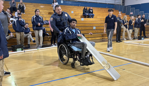 Officer Fahem makes a friend at the PAL vs North Penn Bocce exhibition match on Wednesday
