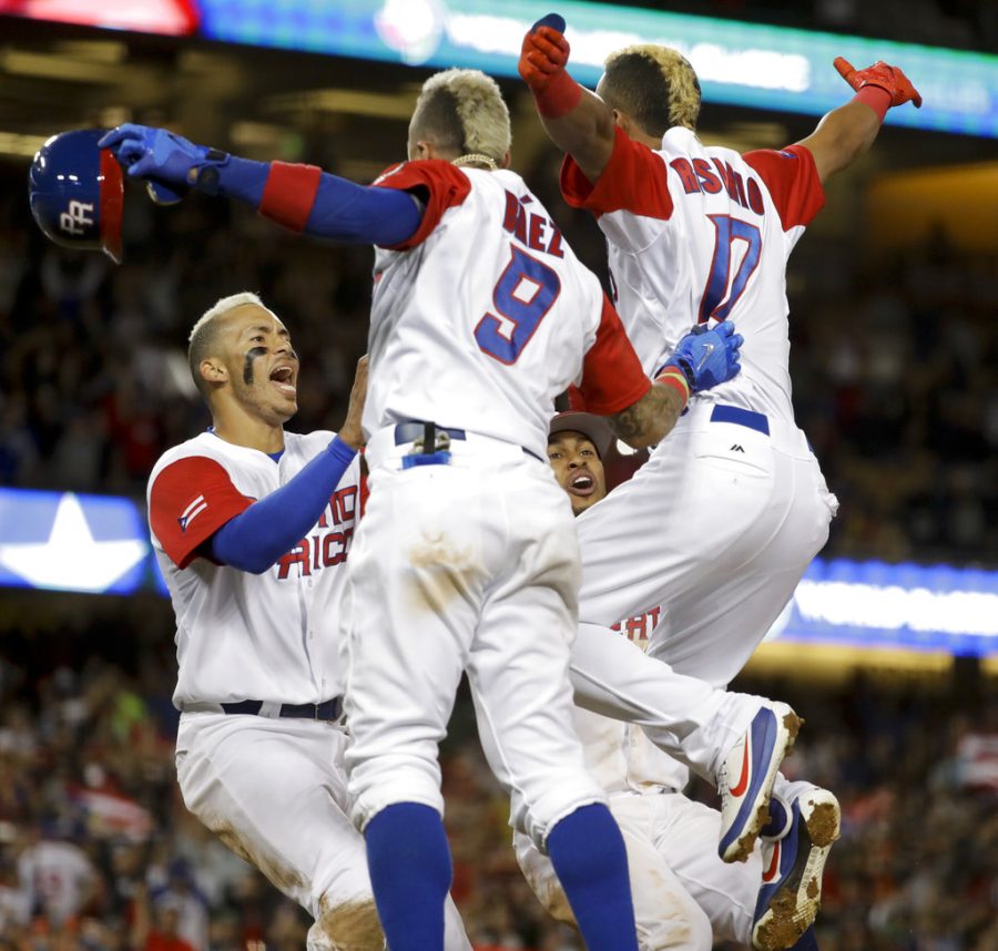 Puerto Ricos Carlos Correa, left, celebrates after scoring the winning run on a hit by Eddie Rosario (17) in the 11th inning of a semifinal against the Netherlands in the World Baseball Classic in Los Angeles, Monday, March 20, 2017. (AP Photo/Chris Carlson)