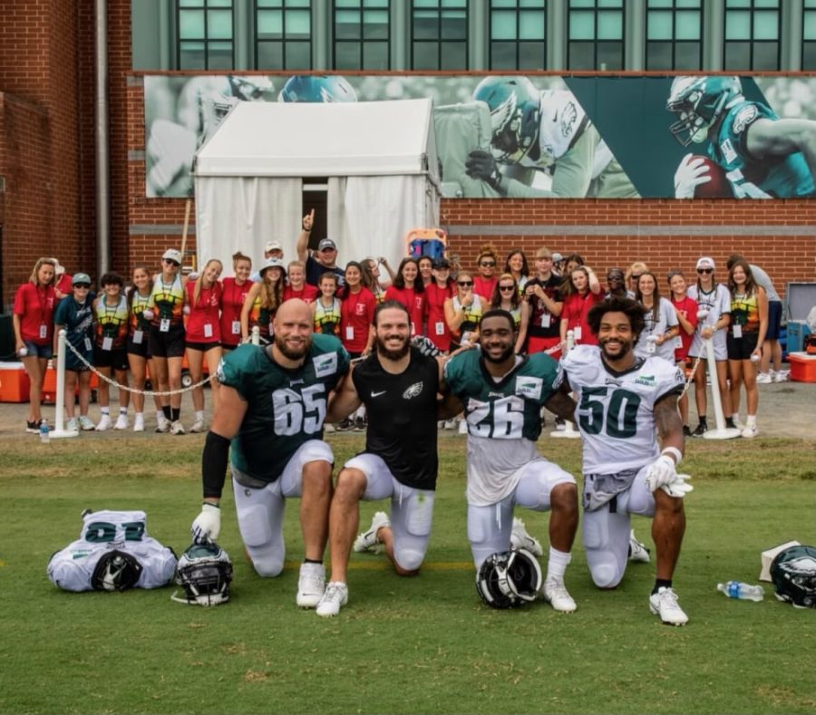 Athena Athletics girls flag football team celebrating their love for the sport with the Philadelphia Eagles at the Eagles training camp.
