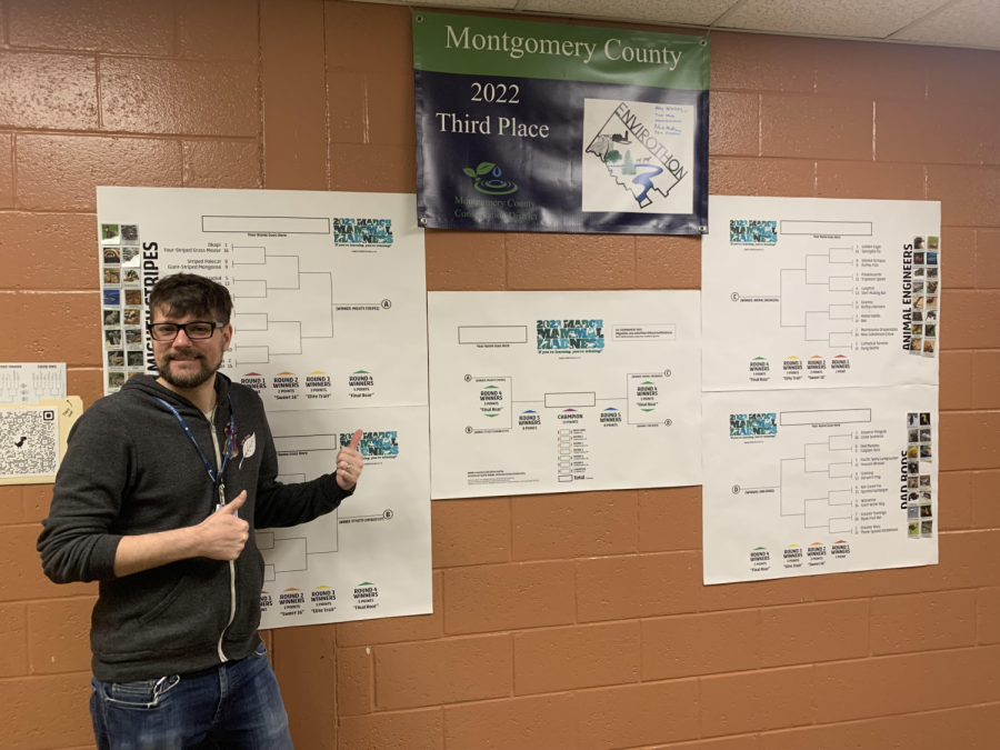 Mr.+Collier+poses+with+his+giant+March+Mammal+Madness+bracket+outside+his+room.