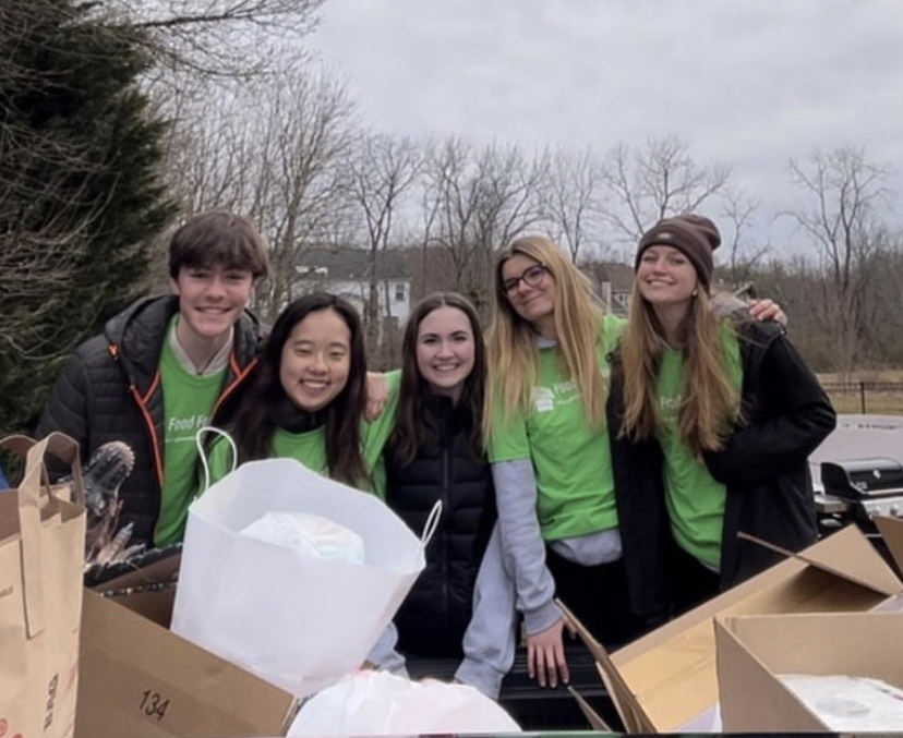 Derek Schneider, Katie Seo, Kylie Cooke, Claire Drouineau, and Kate Romano after a successful neighborhood food drive.