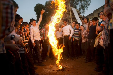 Ultra-Orthodox Jewish youths play with fire during the Jewish holiday of Lag BaOmer in Bnei Brak, Israel, Wednesday, May 2, 2018. The holiday marks the end of a plague said to have decimated Jews during the Roman times. (AP Photo/Oded Balilty)