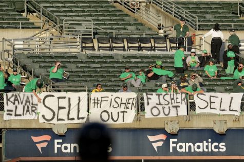 Oakland Athletics fans hang signs at RingCentral Coliseum to protest the teams potential move to Las Vegas and to call for team owner John Fisher and president Dave Kaval to sell the team during a baseball game between the Athletics and the Cincinnati Reds in Oakland, Calif., Friday, April 28, 2023. (AP Photo/Jeff Chiu)