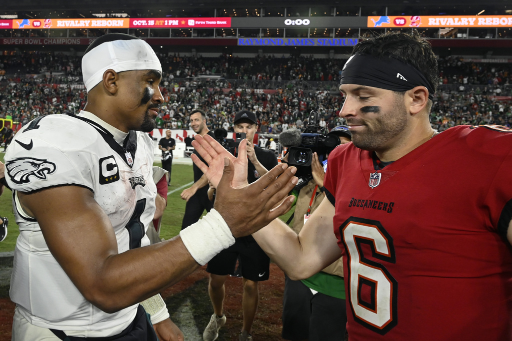 Philadelphia Eagles Jalen Hurts, left, and Tampa Bay Buccaneers Baker Mayfield meet after an NFL football game, Monday, Sept. 25, 2023, in Tampa, Fla. (AP Photo/Jason Behnken)