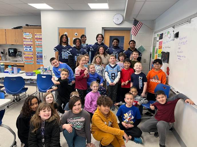 Knights pose with former teacher and Knapp Elementary students.