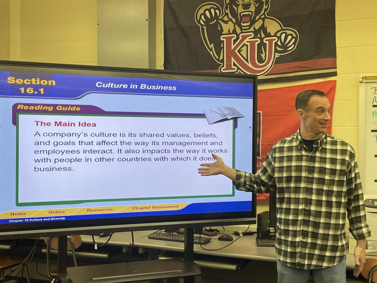 BOVELL AND HIS BUSINESS ADMIN. STUDENTS: Mr. Edward Bovell (seen above) teaching his seniors chapter 16 of the business administration course, Culture in Business.