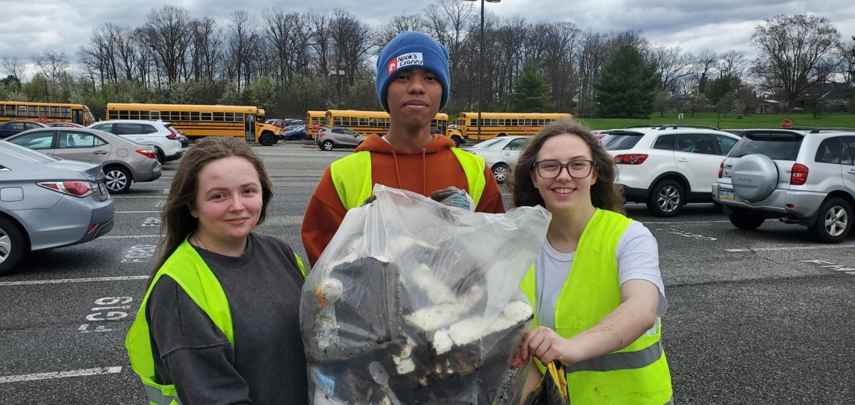 Casper Pembroke, Julius Weathers, and Aurora Pembroke showing off all of the trash they collected.
