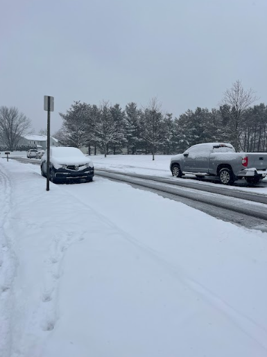 Cars driving safely through snow 