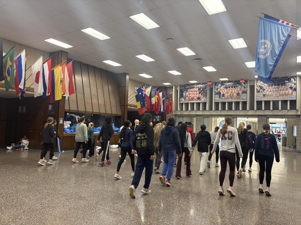 Girl’s winter track does drills in the main hallway (instead of in the Aux gym because the jumpers are using it)