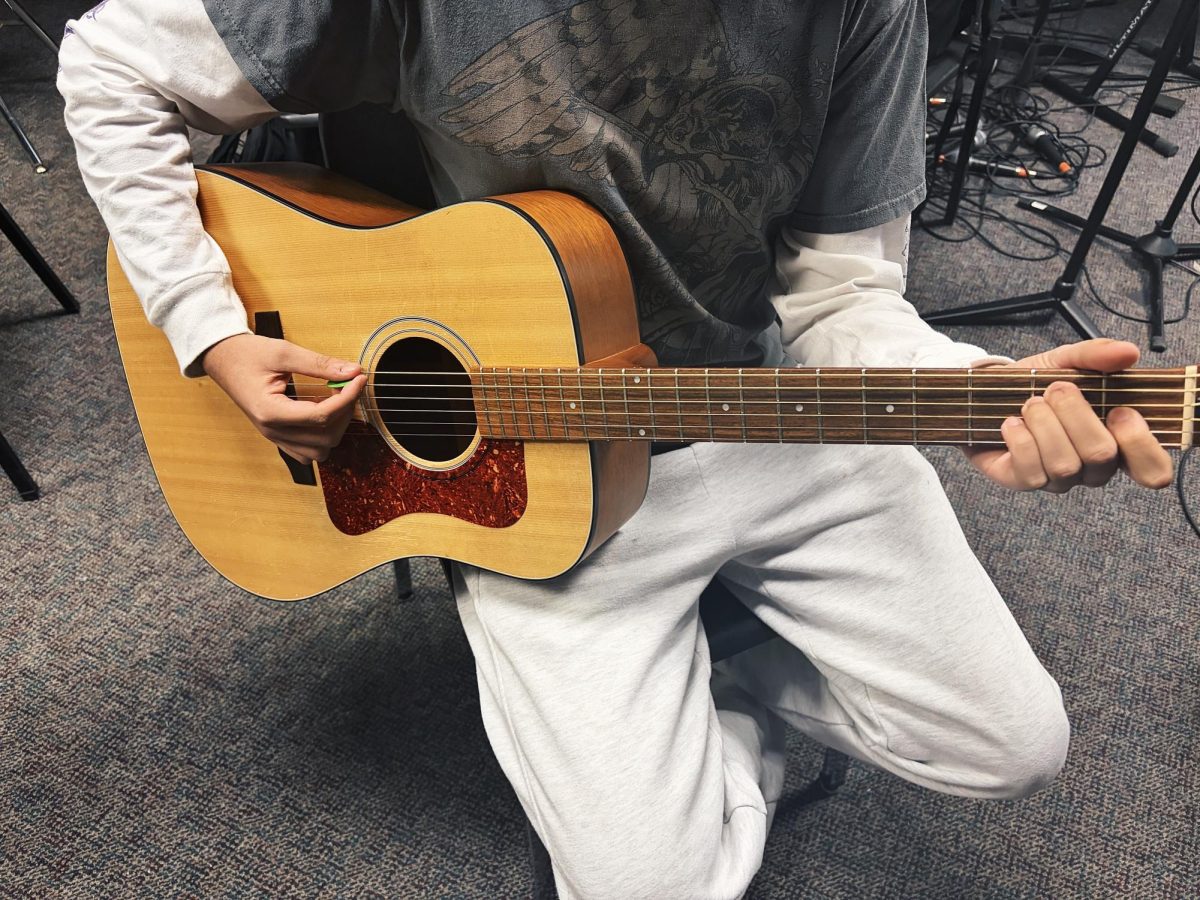 A moment in every chord. Arzyan Alam strums the guitar. 