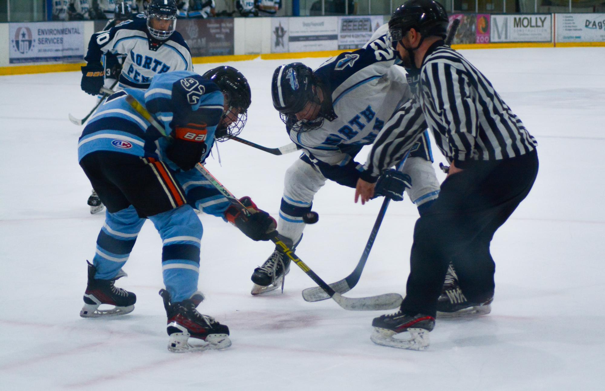 Chris Silvotti lines up for a faceoff against Shawnee sophomore Julian Byrne.