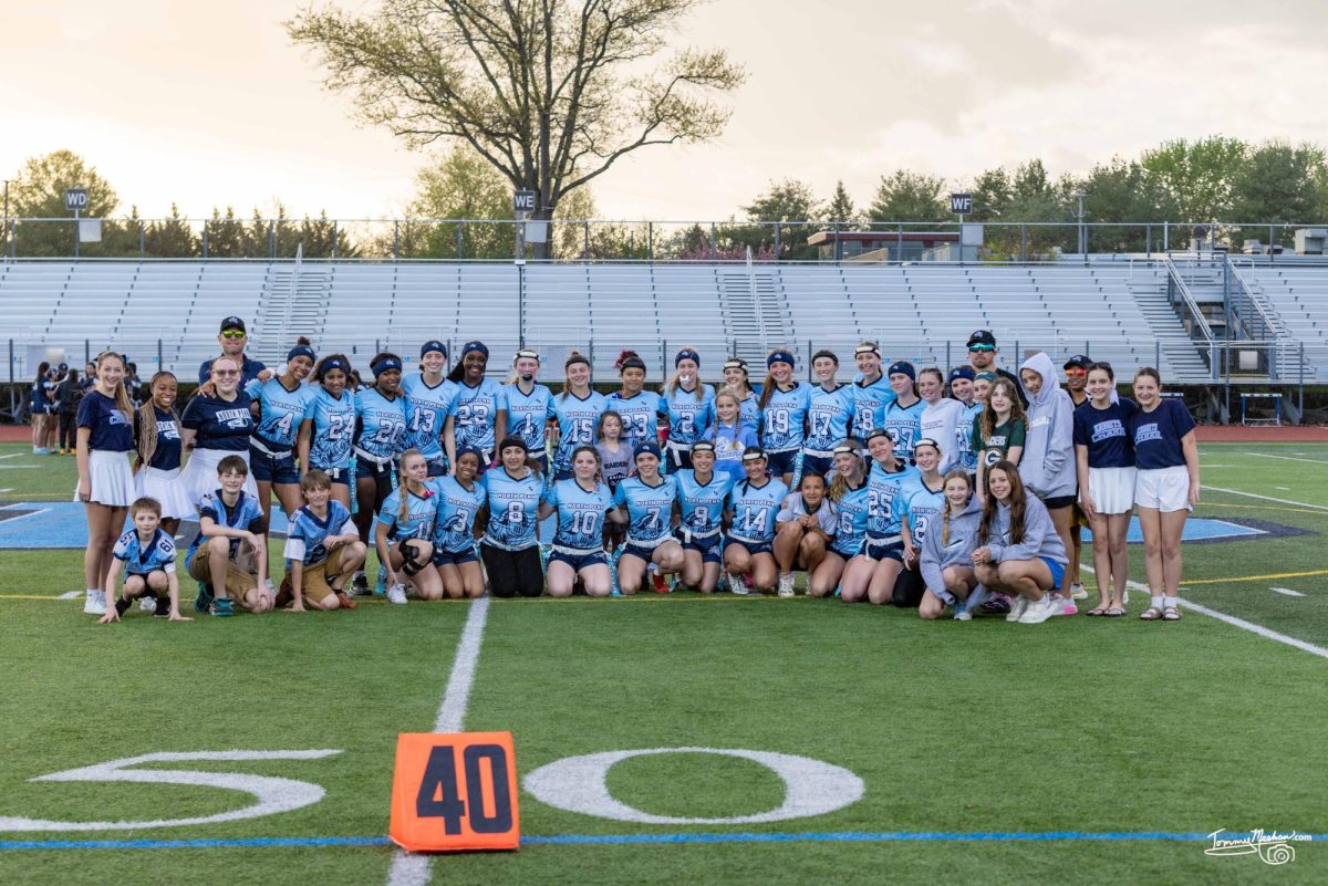 North Penn poses with members of the community pregame before their Community Night matchup with Springford on Friday.